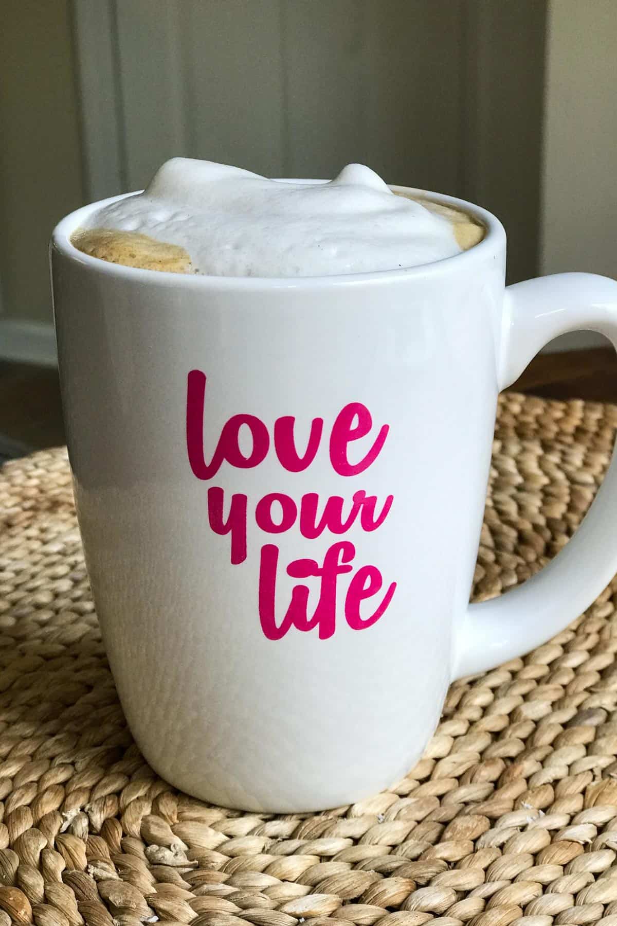 Dairy-free cappuccino in mug that says "love your life"