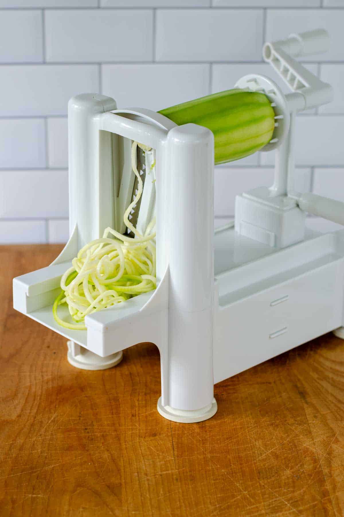 Vegetable spiraizer making zucchini noodles.