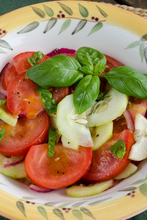 Easy tomato cucumber salad is perfect for a summer barbecue. With homegrown cucumbers, tomatoes, and basil, It's naturally paleo, gluten-free, and grain-free. | cookeatpaleo.com