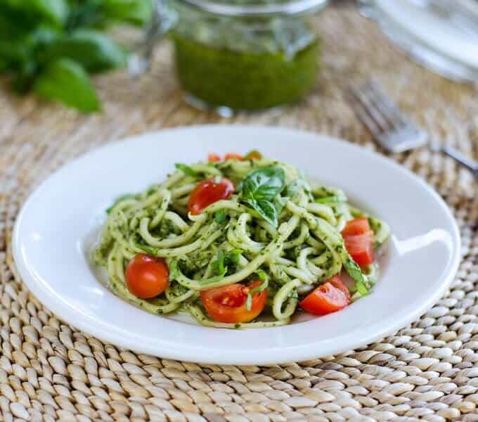 zucchini noodles with pesto and cherry tomatoes on plate