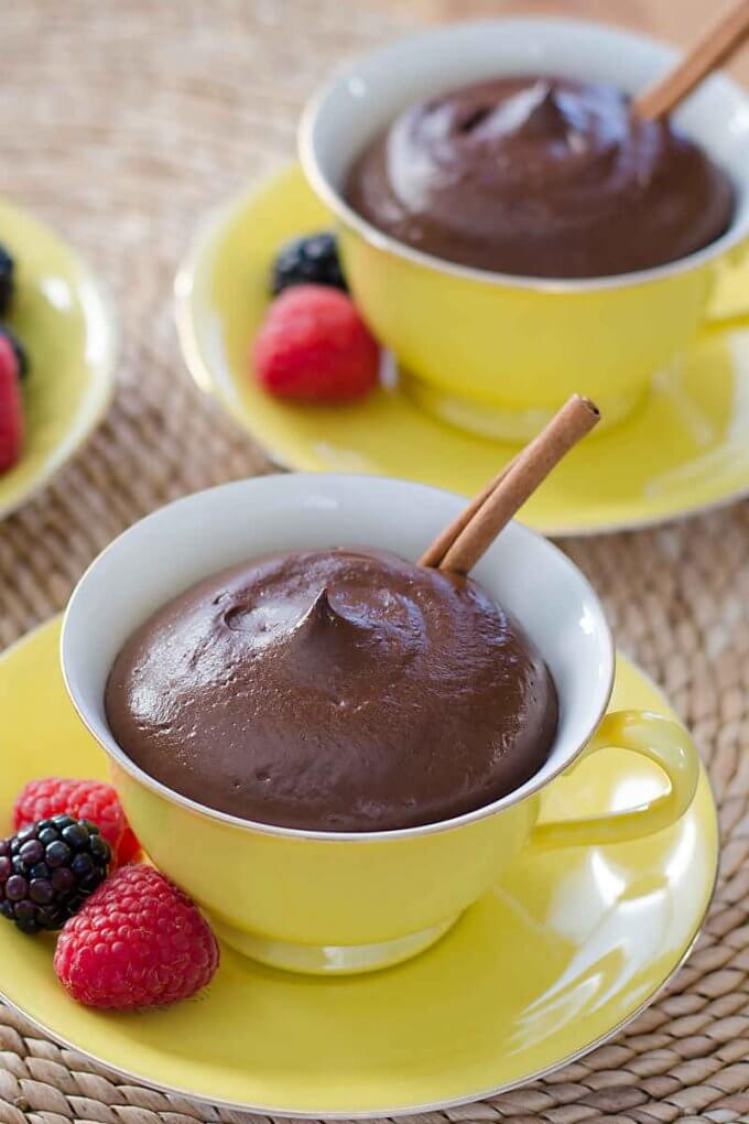 Avocado chocolate mousse with berries and cinnamon stick