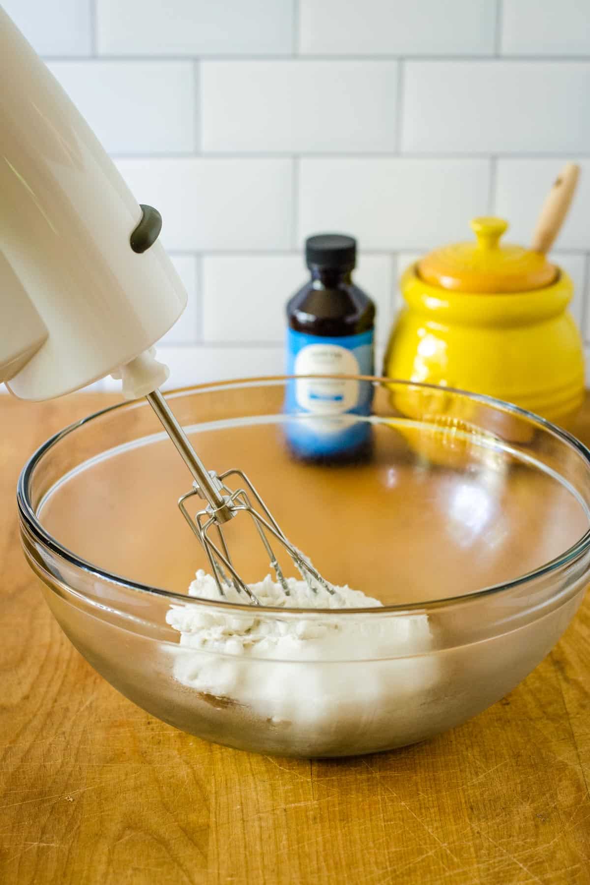 Coconut cream in glass bowl with mixer