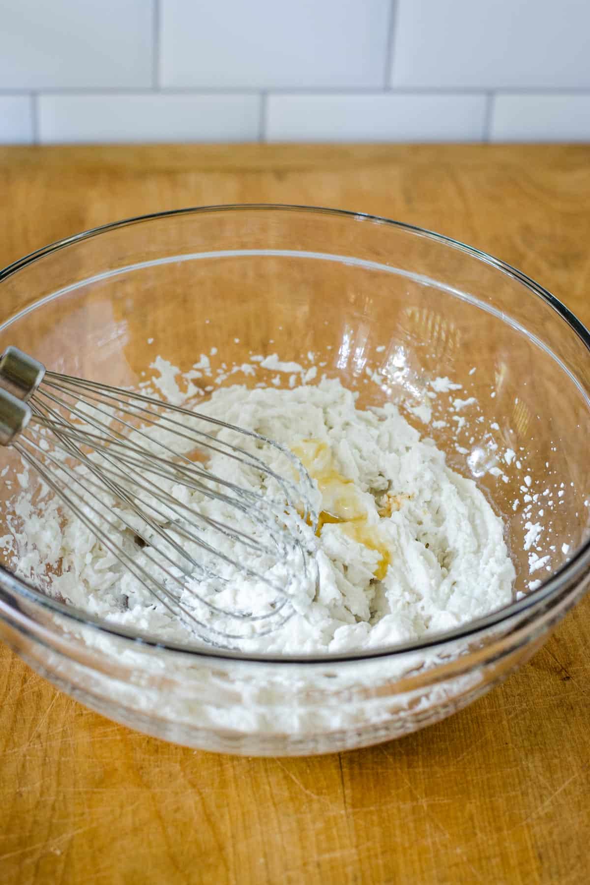Adding vanilla and honey to bowl of whipped cream