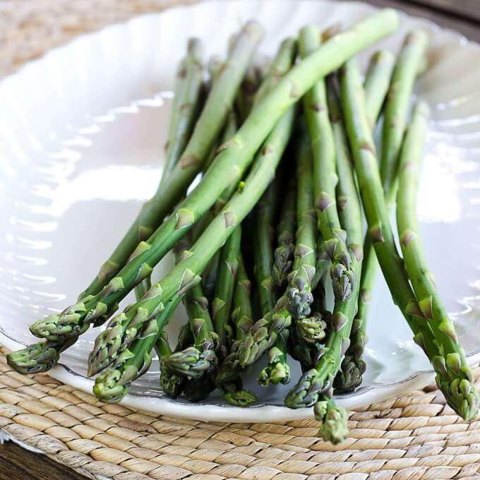 Fresh asparagus on white platter