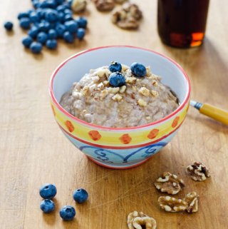 Paleo oatmeal with blueberries, walnuts and maple syrup