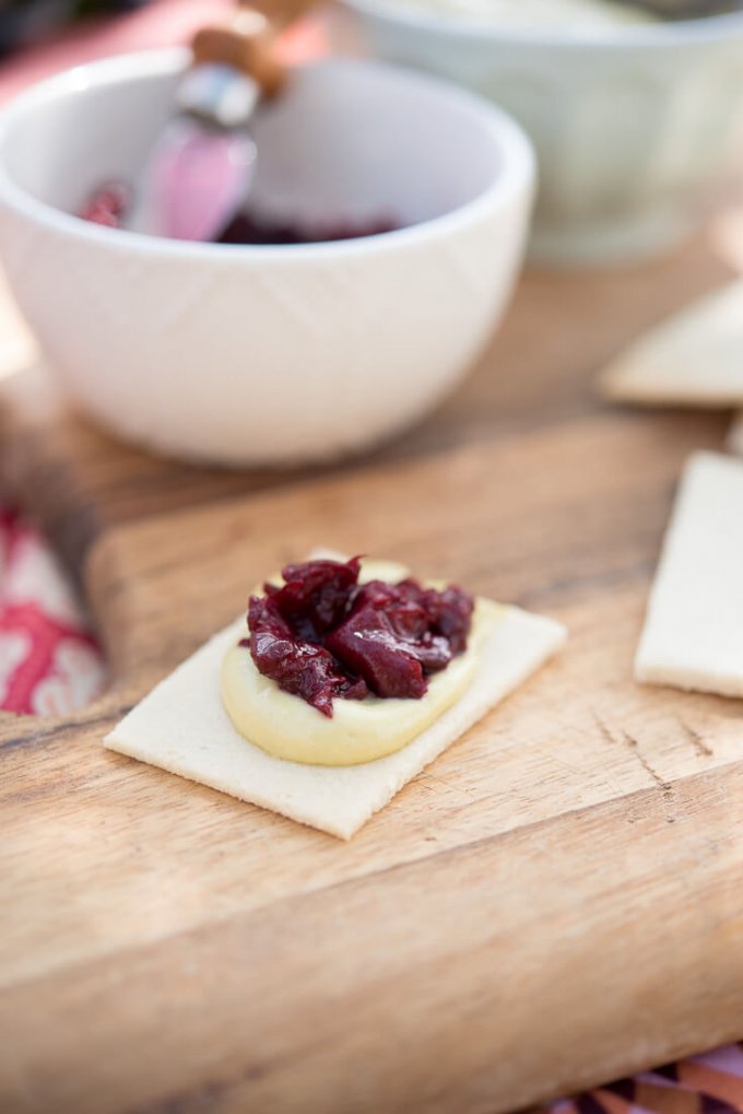 Basil cashew cheese spread with cherry balsamic jam on paleo crackers 