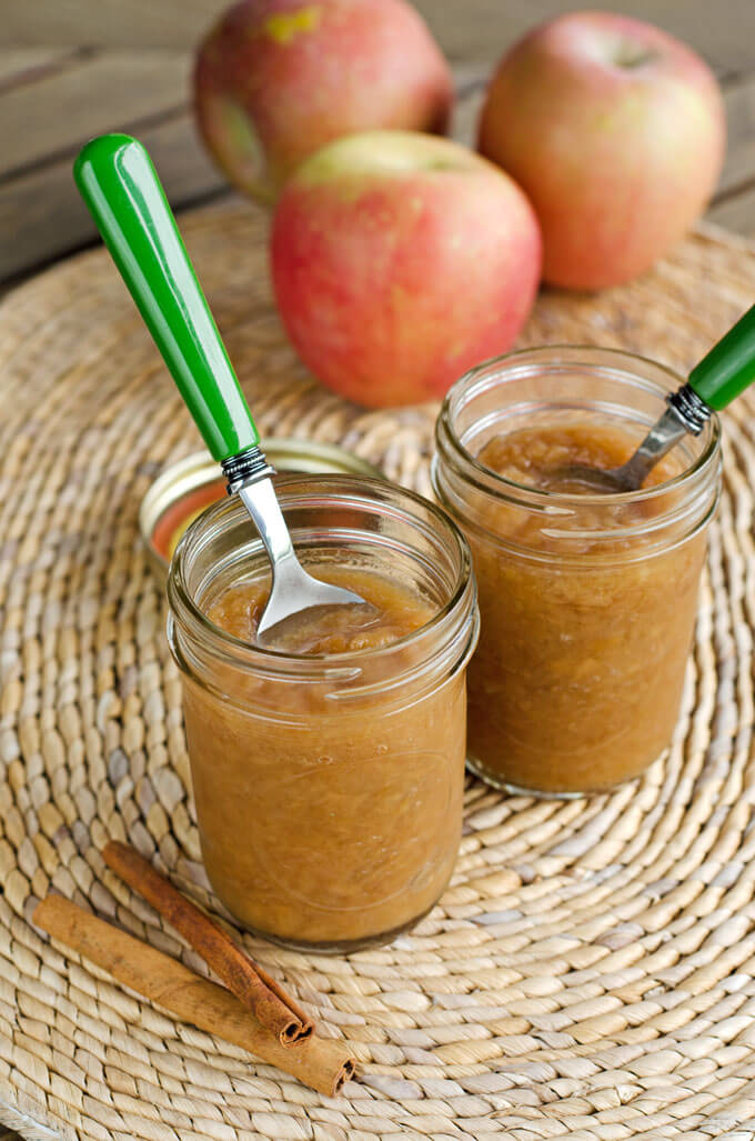 Slow cooker apple sauce in mason jars with green spoon