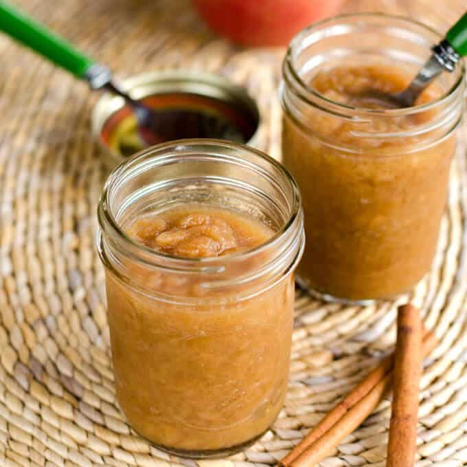 Homemade applesauce in mason jars with cinnamon sticks
