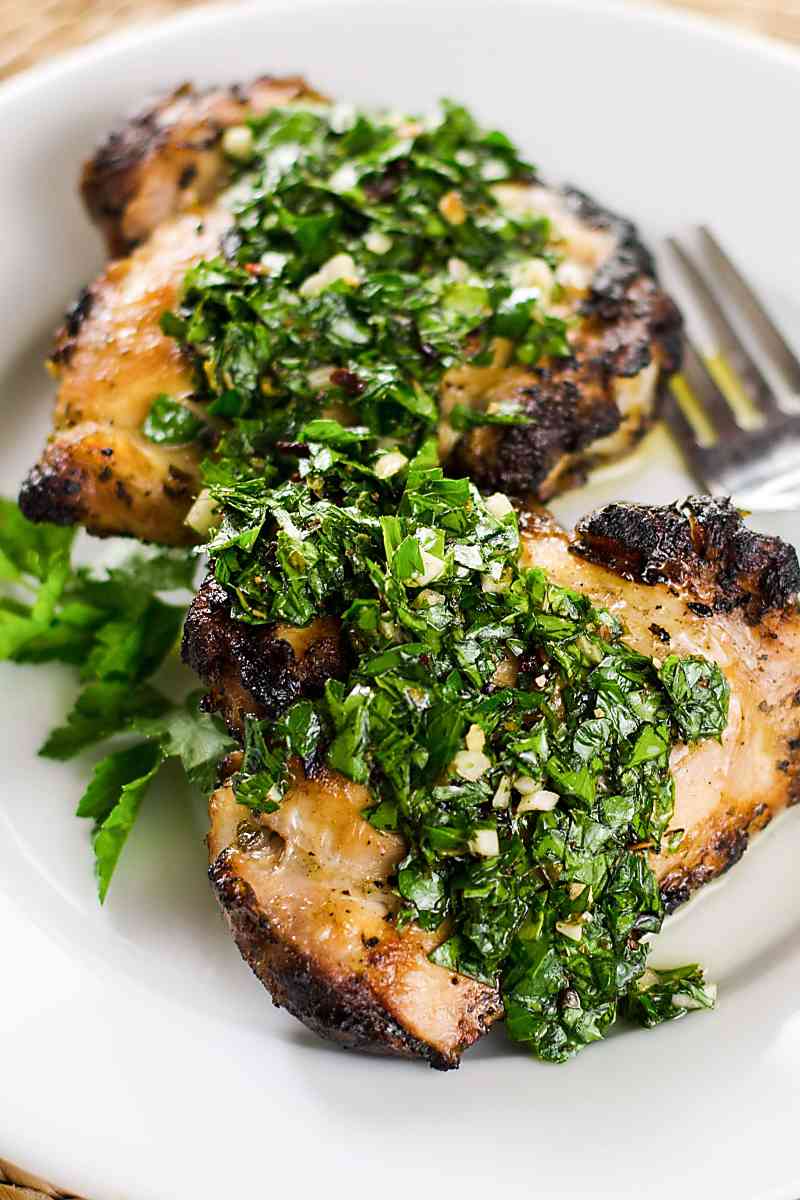 Chimichurri sauce over grilled chicken thighs