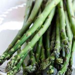 Raw asparagus on white platter