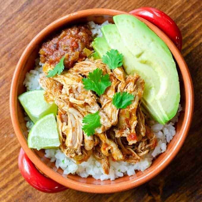 Salsa chicken over cauliflower rice with avocado and lime