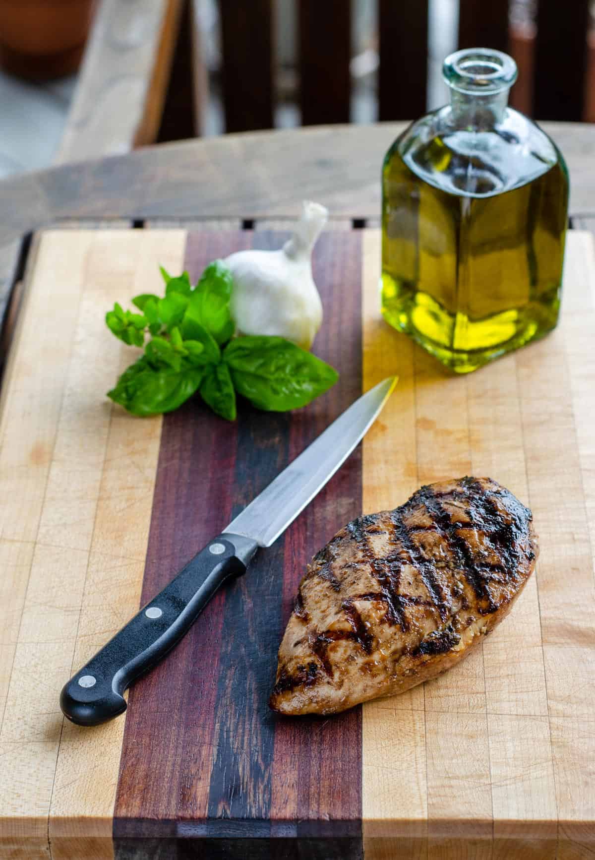 Grilled boneless chicken breast on cutting board