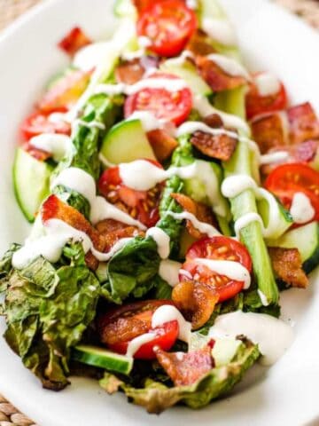 Grilled romaine salad with bacon, tomatoes and ranch dressing