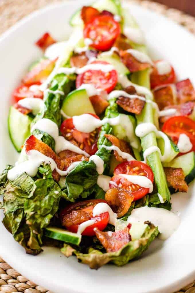 Grilled romaine salad with bacon, tomatoes and ranch dressing