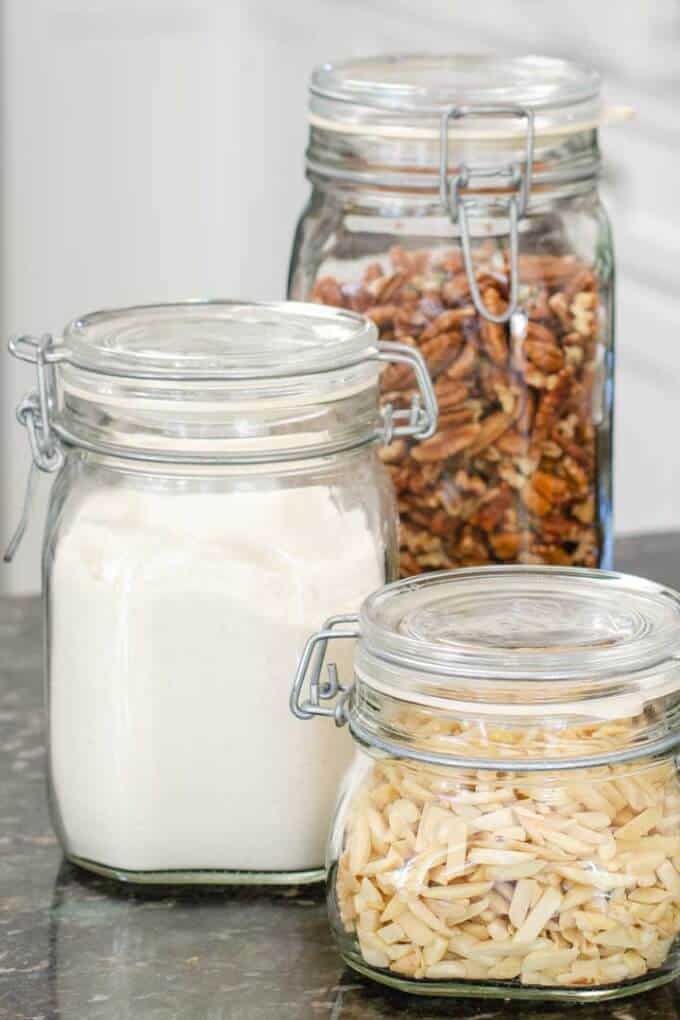 Pantry dry goods in glass jars - coconut flour, almonds, pecans