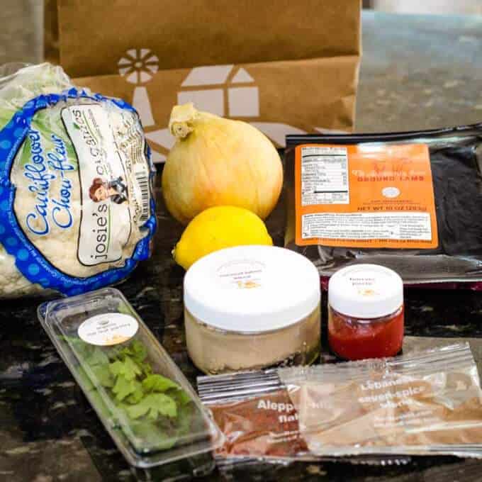 Sun Basket meal kit ingredients - cauliflower, onion, lemon, lamb, herbs, spices