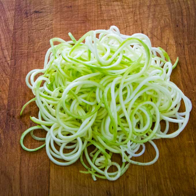 Zucchini noodles on cutting board