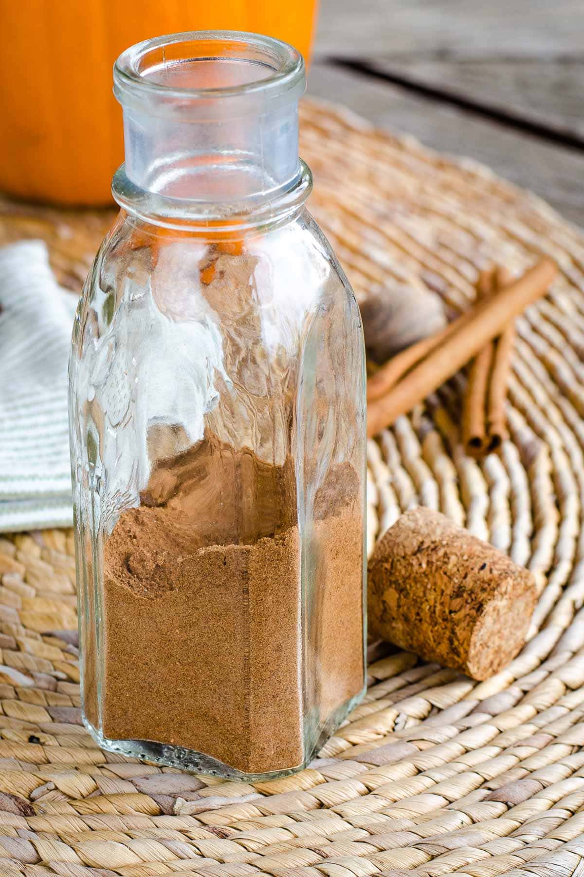 Homemade pumpkin pie spice in glass bottle