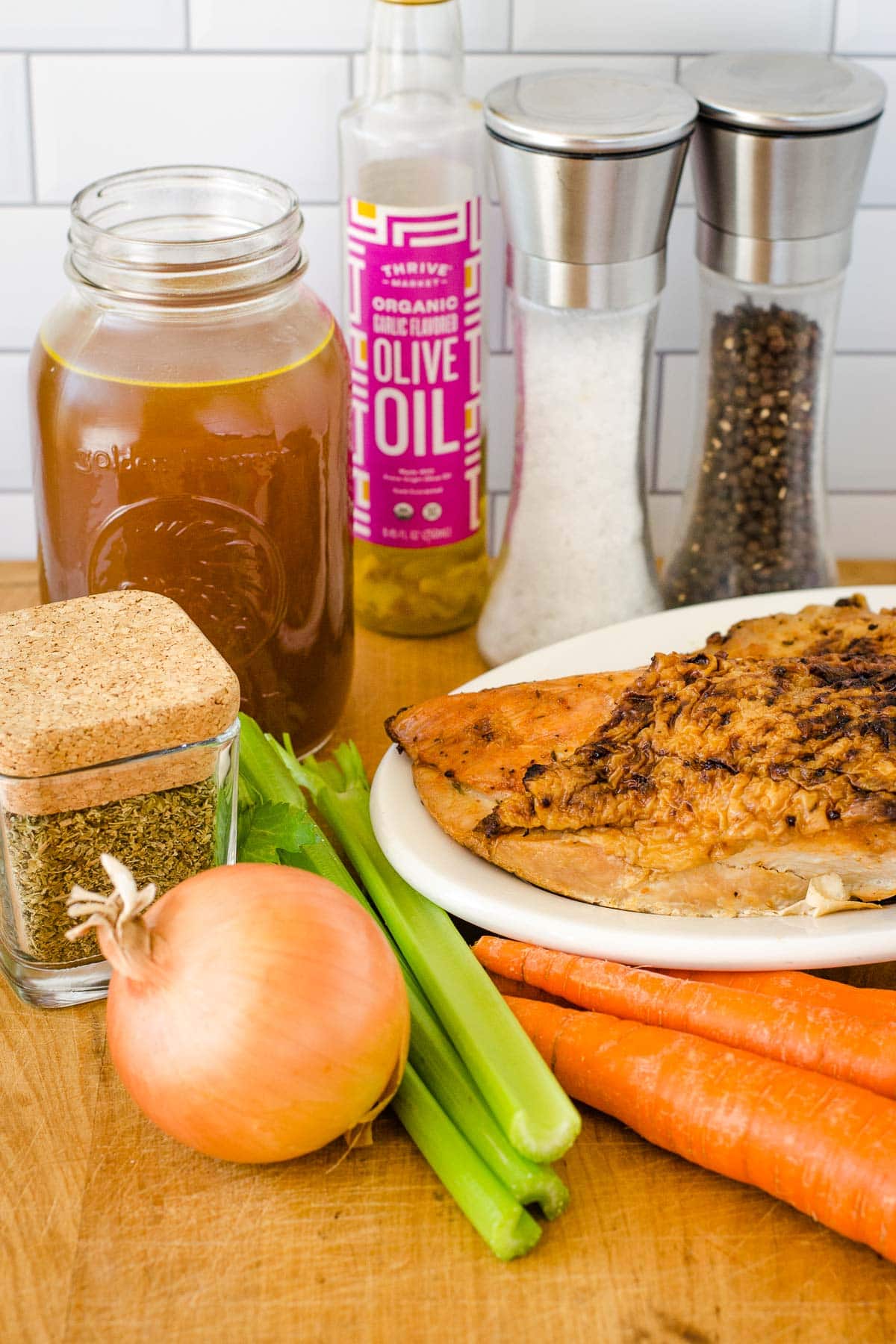 Chicken stock, olive oil, salt, pepper, poultry seasoning, onion, celery, carrots and cooked turkey breast.