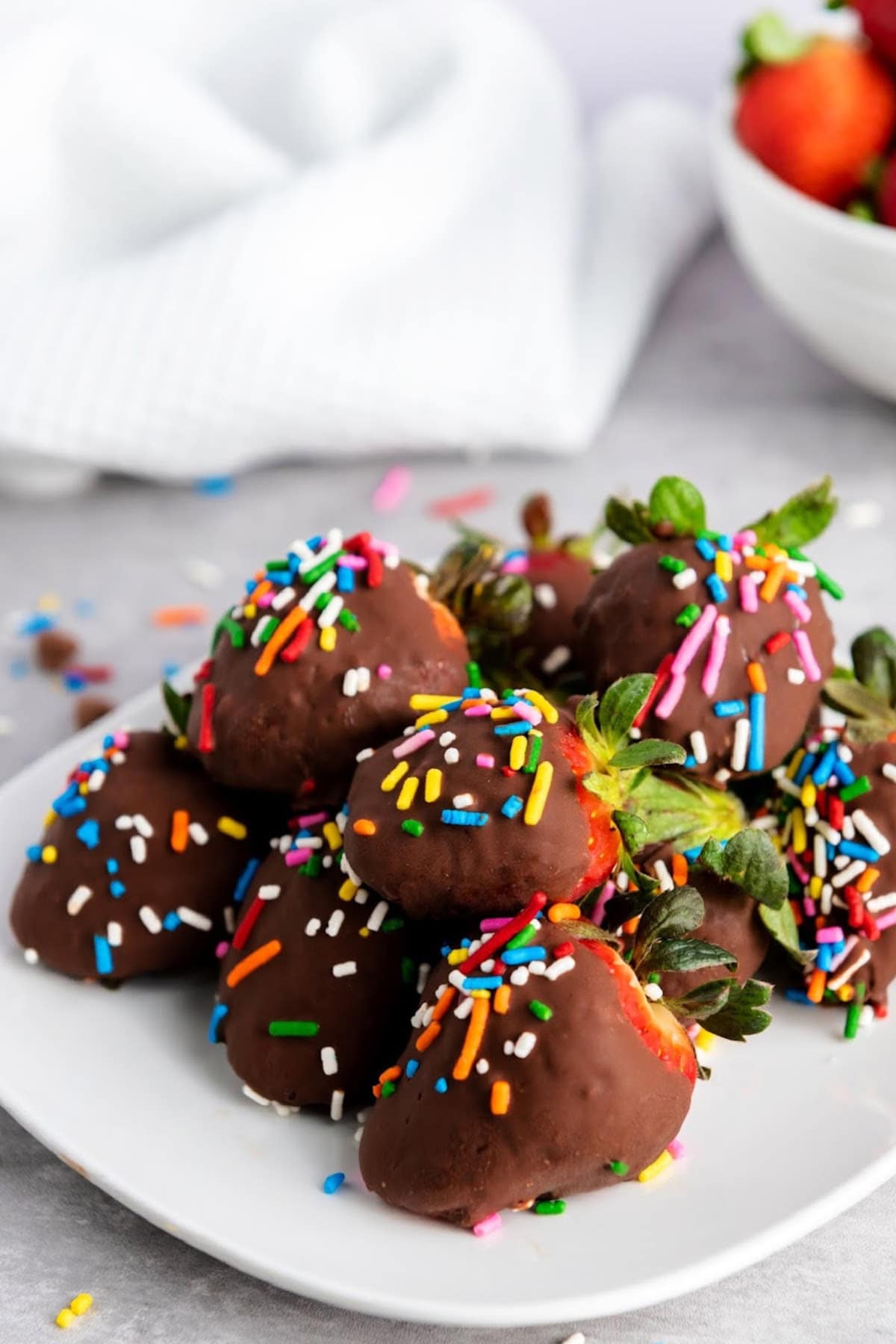 Chocolate strawberries on white plate.