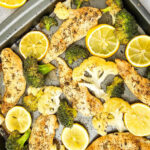 Oven baked sheet pan chicken and veggies with broccoli, cauliflower and lemon..