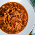Slow cooker chicken marinara in white bowl.