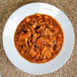 Slow cooker chicken marinara in white bowl.