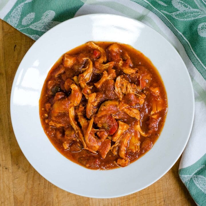 Slow cooker chicken marinara in white bowl.