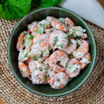 Shrimp salad in a green bowl.