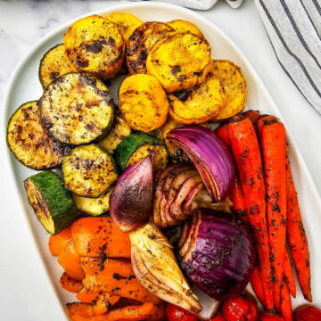 Grilled marinated vegetables including zucchini, peppers, onions, carrots and cherry tomatoes.