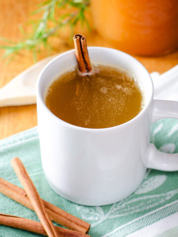 Hot apple cider with cinnamon sticks.